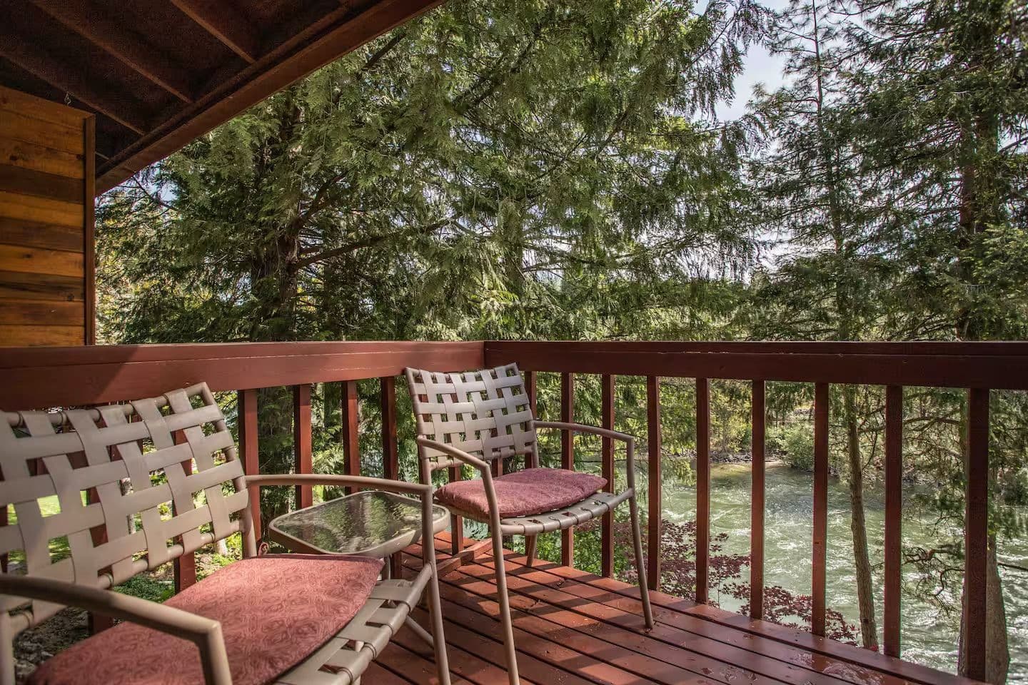 wooden patio over river setting with greenery